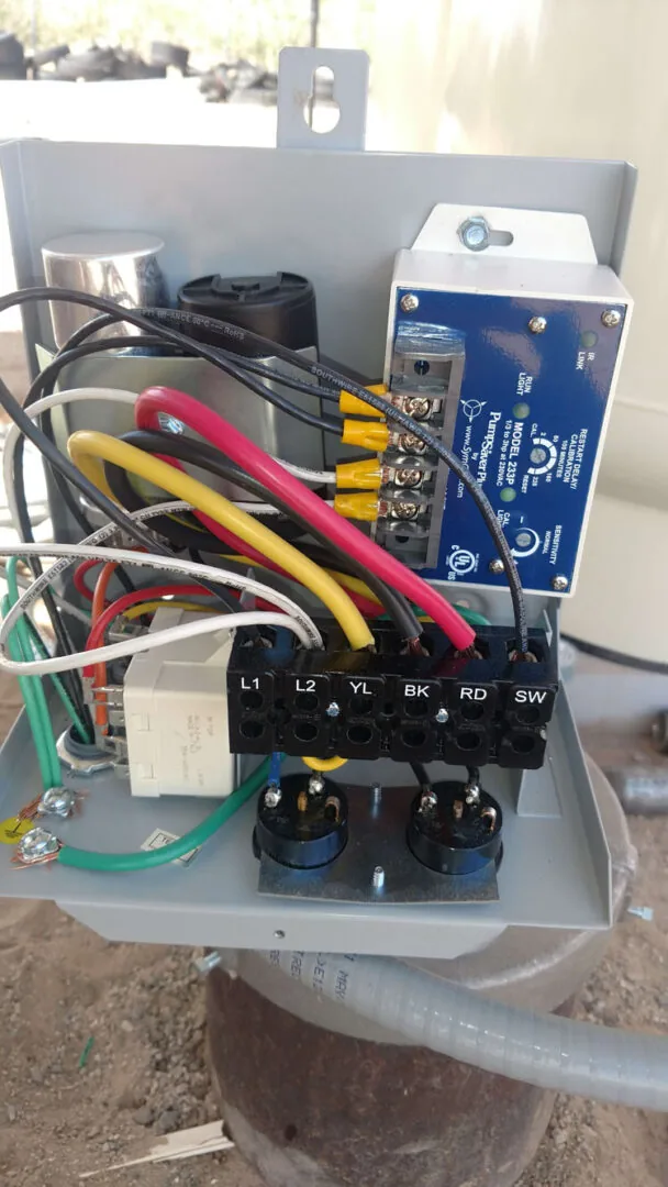 An open well pump control box with new wiring